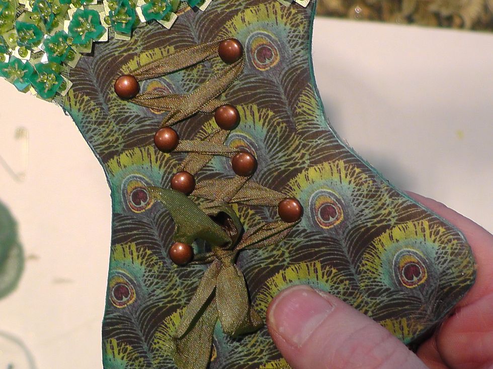 I used some brads to create my corseted look on this one