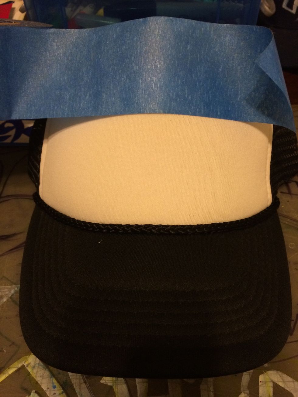 I used the painters tape as guidelines for how big and straight  I want the design to be.  This is optional as you can simply draw on the hat freehand.