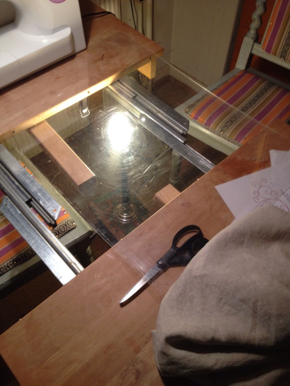 I used the plexiglas from a picture frame. Pulled out my dinner table, placed a lamp underneath and placed the plexiglas over the gap. My very own light table.