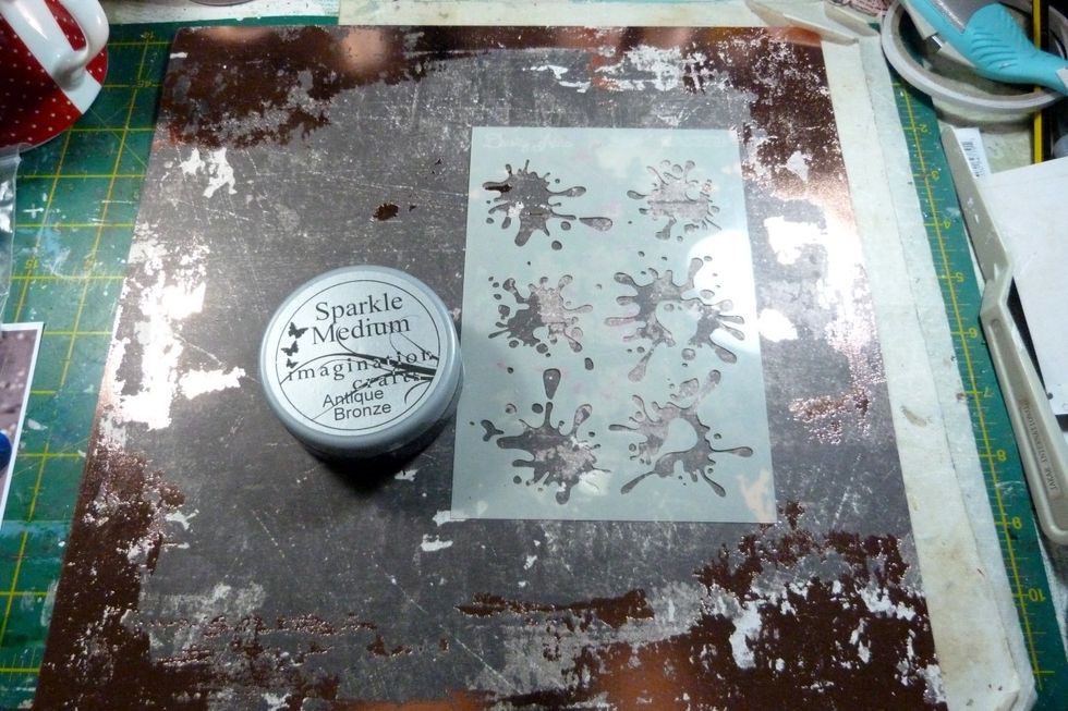I used the Rossibelle paper 'Notes & Scribbles' as my background paper. I used a Bronze glitter paste through the stencil from the Mediums kit & added 'spats' in a triangle shape from right hand side.