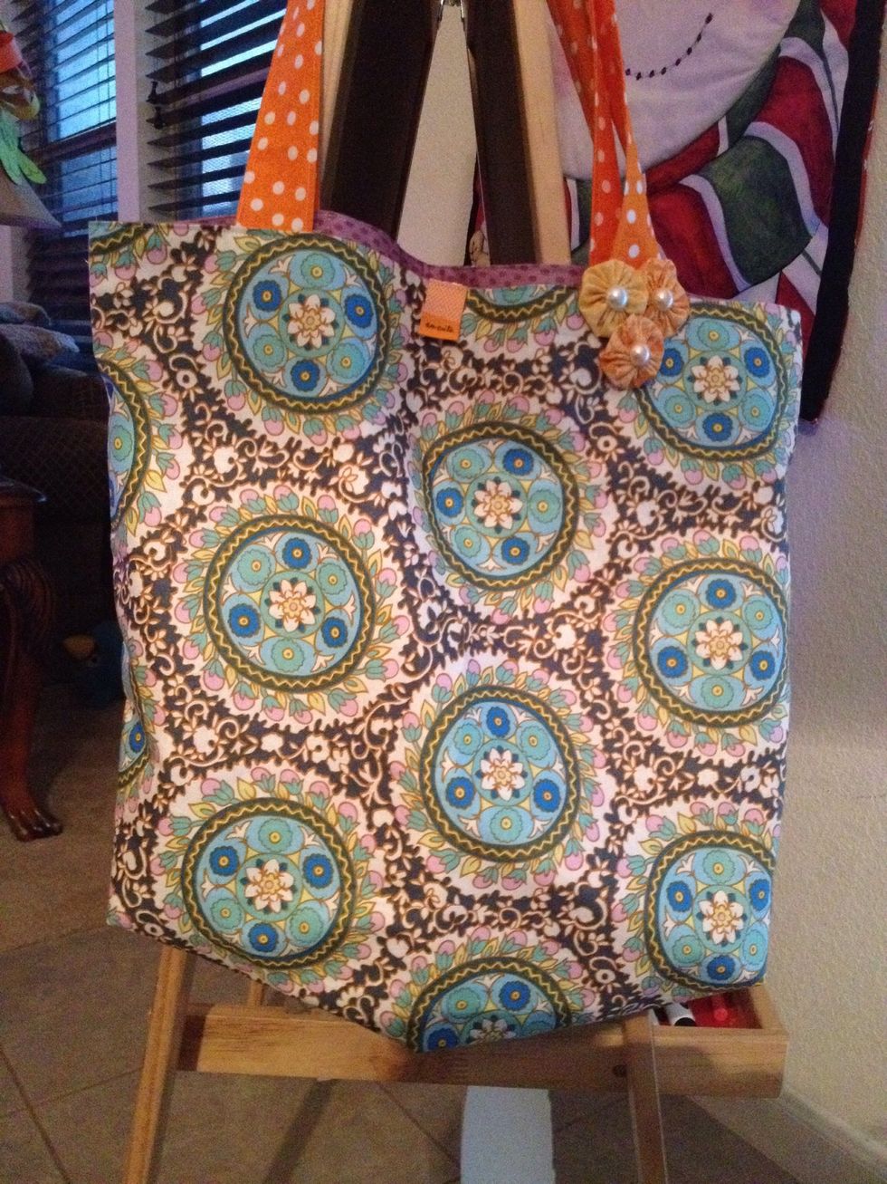 I used this to embellish a tote. You can cluster a few of the flowers and use a fabric backing to attach the flowers to make a headband or a brooch.
