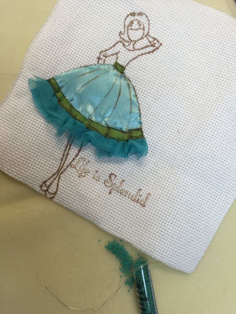 I used tiny Delica beads to create a polka dot pattern on her shirt!