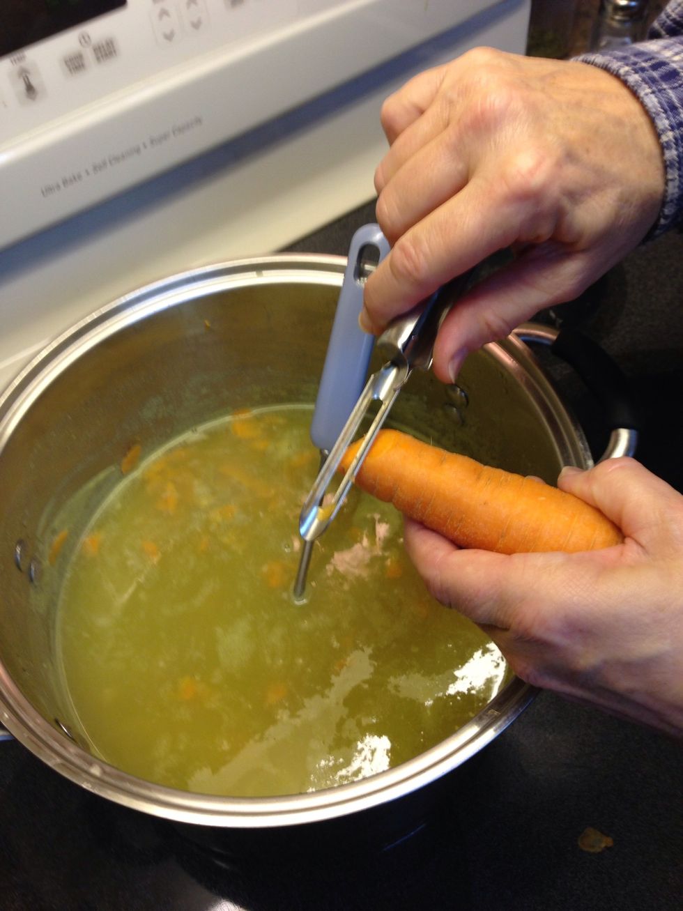 I usually add 1-2 cups water now. Then grate one fresh carrot into soup for color, extra nutrition, texture & flavor. Do not simmer any longer.