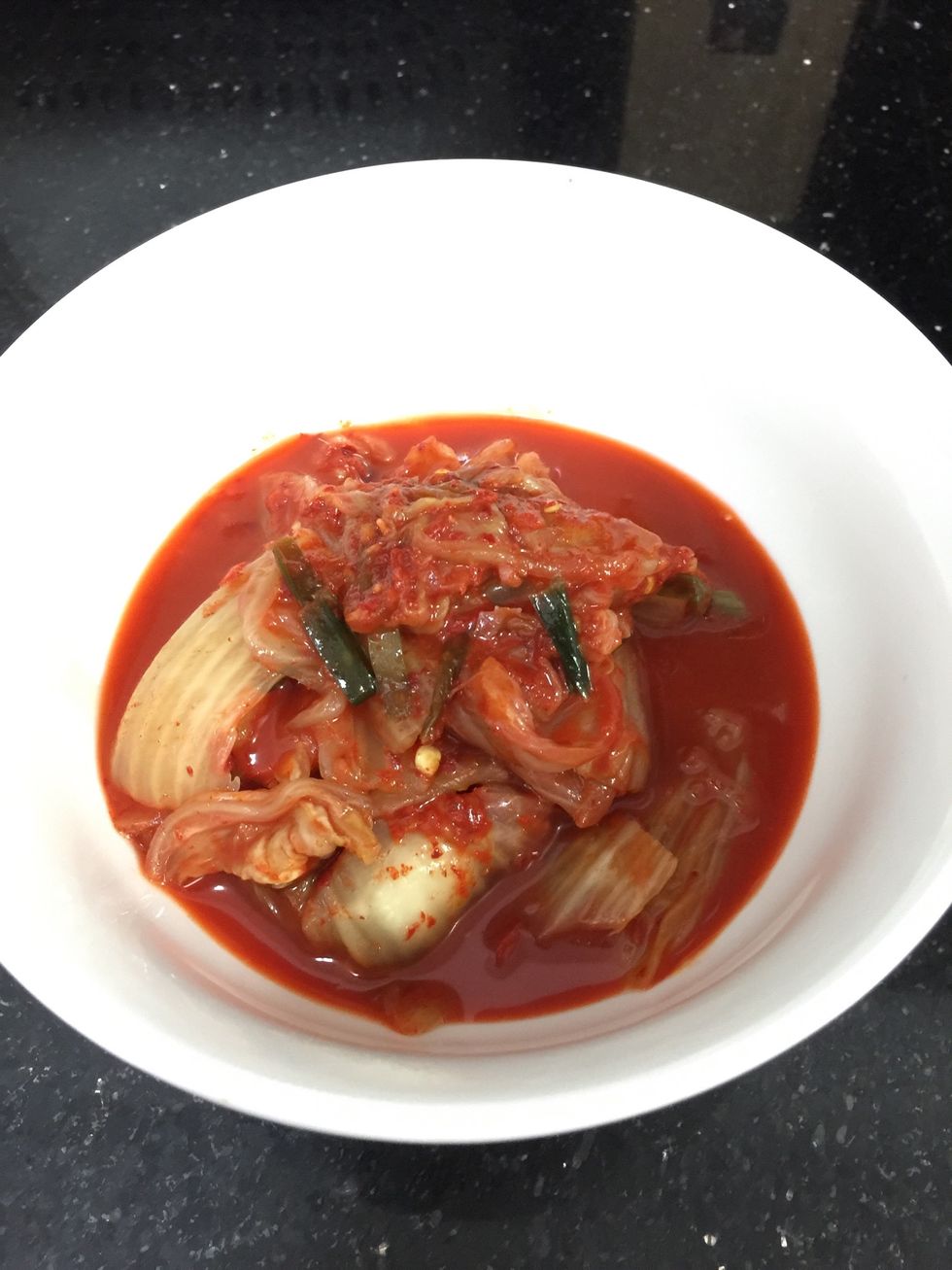 I usually buy freshly made kimchi from Korean store and keep in the fridge for at least 2 weeks to get the sourly taste. The longer you keep, the sour it gets.