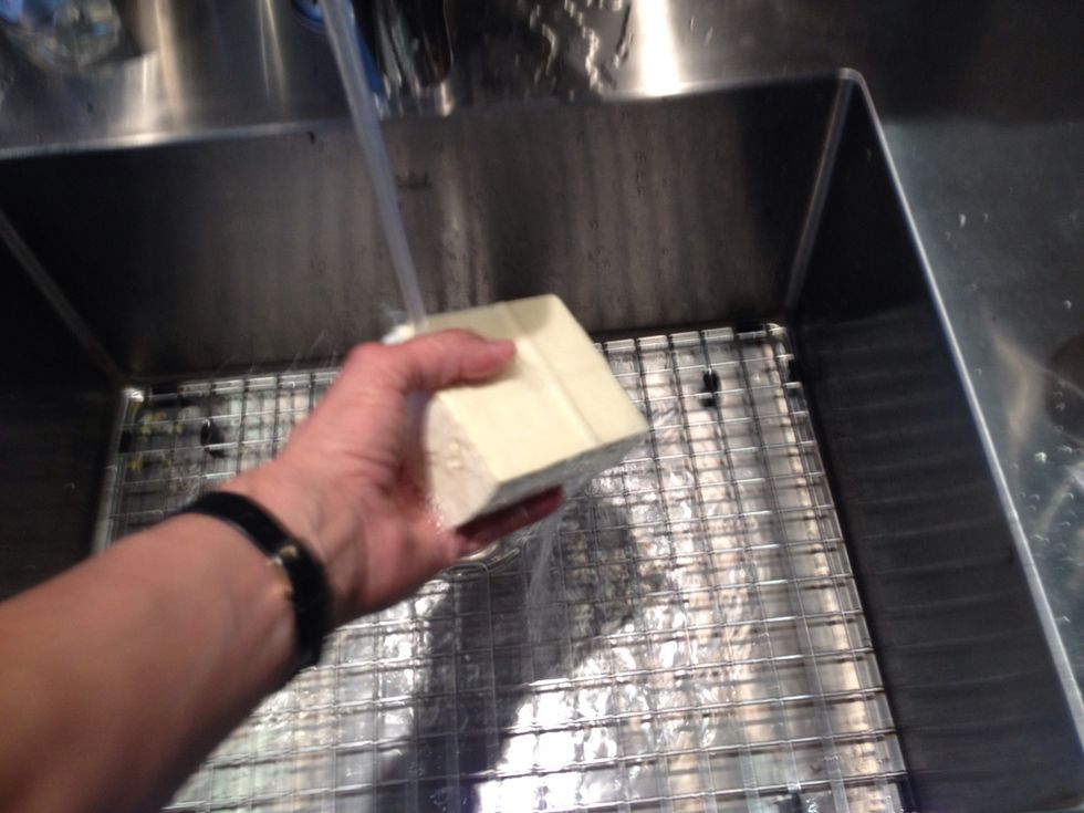 I usually rinse the tofu. It might be superstitious behavior but I worked in a health food store for a while, and rinsing the bulk tofu was one of my tasks.