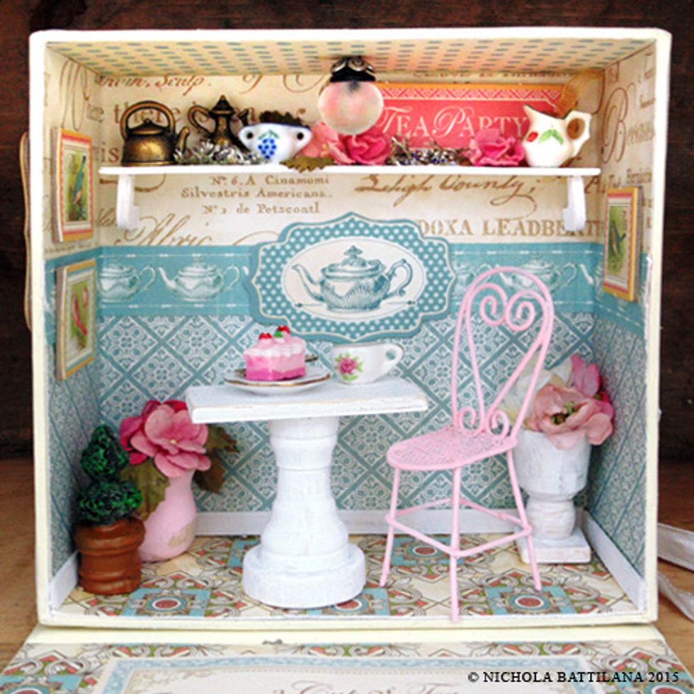 I've added a wire chair, miniature slice of cake and teacups from alphastamps.com. (You could make your own chair from a champagne cage.) Glue these in place or leave loose for playing :)