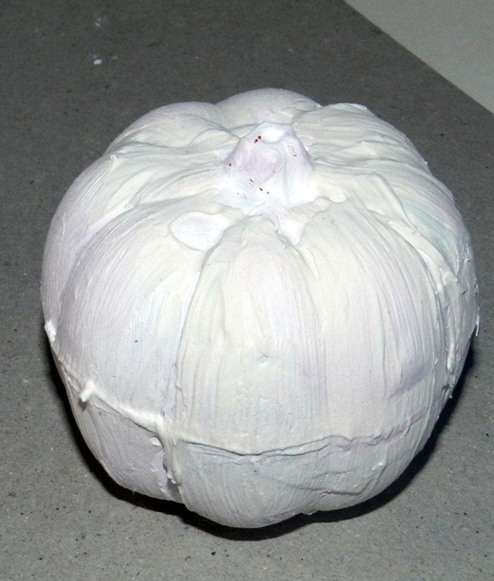 I've covered a plastic pumpkin using acrylic gesso.