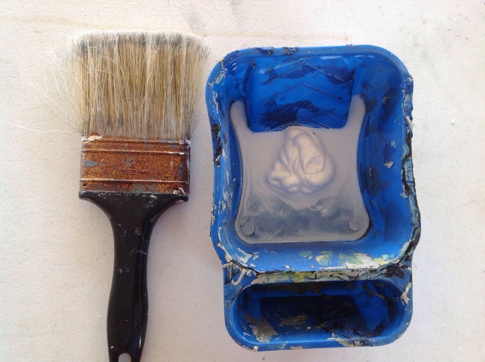 I've decided to go ahead and prime my canvas while it's damp, but you can wait. I'm using watered down white acrylic and a big brush.