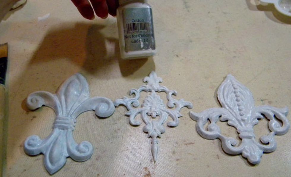 I want the Melissa Frances Appliques to look like worn pieces of iron or metal that I'd found at an antique store. So I painted gesso and Cotton Velvet randomly on each piece to start.