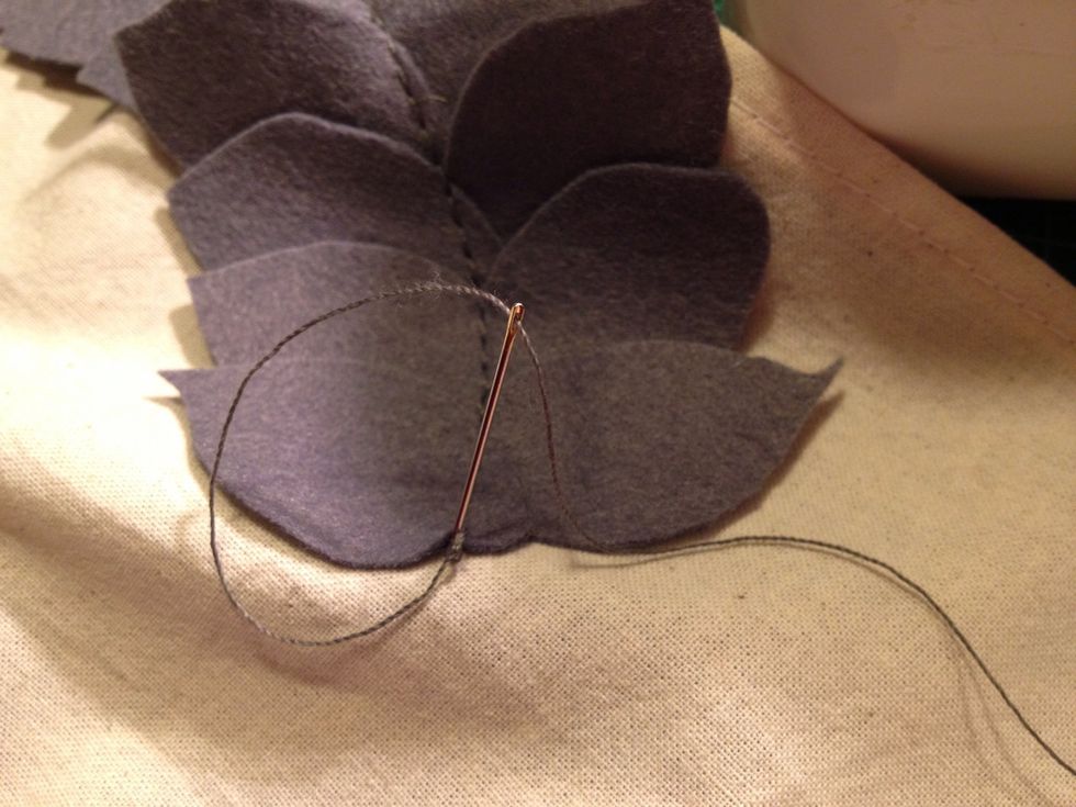 I wanted a clean ending on the garland, so I cut the thread long and using a needle I pulled it on to the backside.