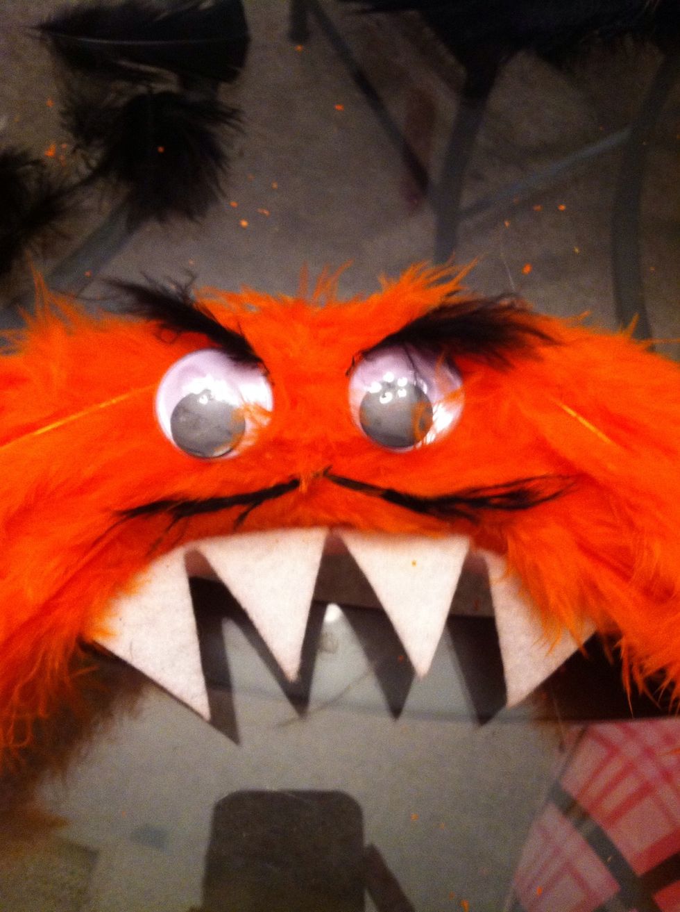 I wanted a French monster, so I added two more small  black feathers for his mustache.