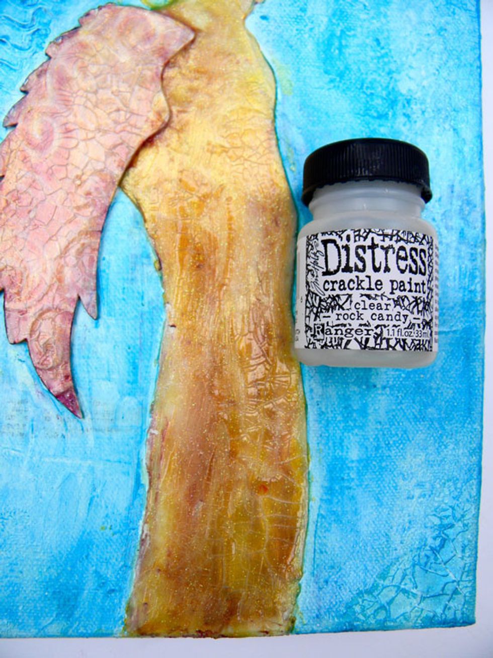 I wanted my canvas to have an "old world" look so I painted thick coats of clear crackle paint around the edges, on the wing and on parts of the angel. Dry completely.