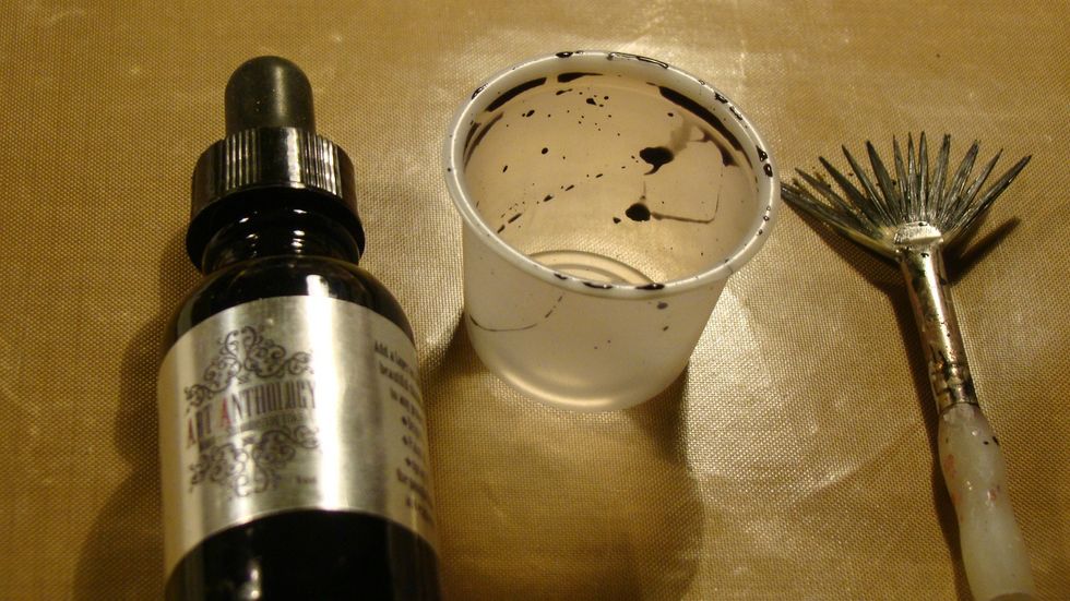 I wanted random stains on the page so I used the rim of a cup. I puddled a bit of my Minx Ink and ran the rim of the top and then stamped it on my layout.