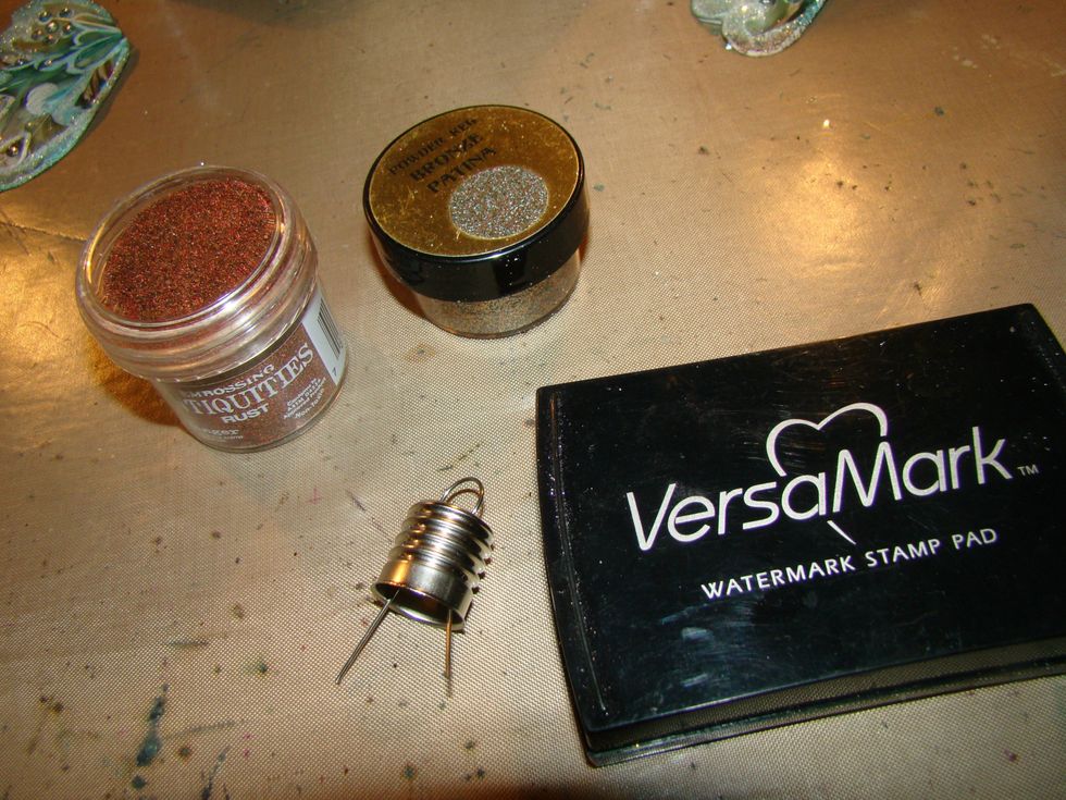 I wanted the cap to look rusty and gave a patina look, so i rubbed VersaMark on the lid and applied Antiquities Rust and Pk Glitz Patina embossing powders, heat set. Be careful the metal gets real hot