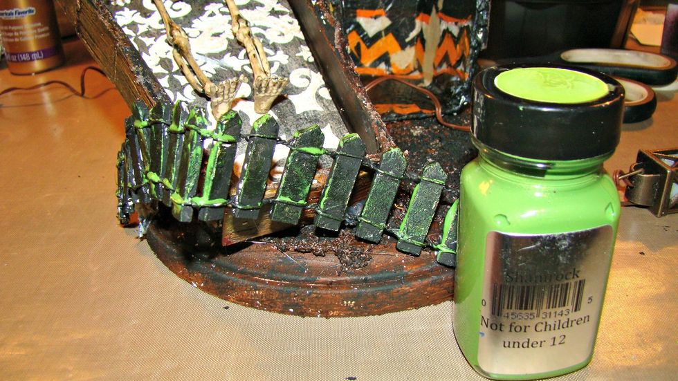 I wanted to add some more eeriness to the project, using my finger rubbed Shamrock Green here and there on the fence.