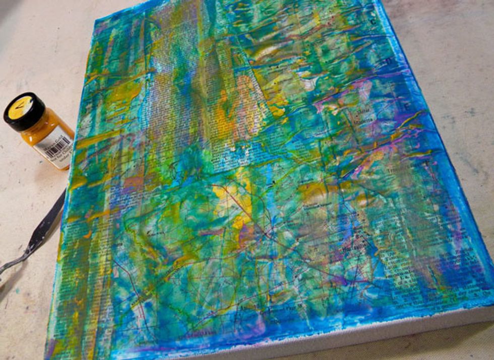 I wanted to have a burst of bright color in the background, as if someone turned on the lights. So I applied Mayan Gold Velvet using the palette knife, especially to the center of the canvas.