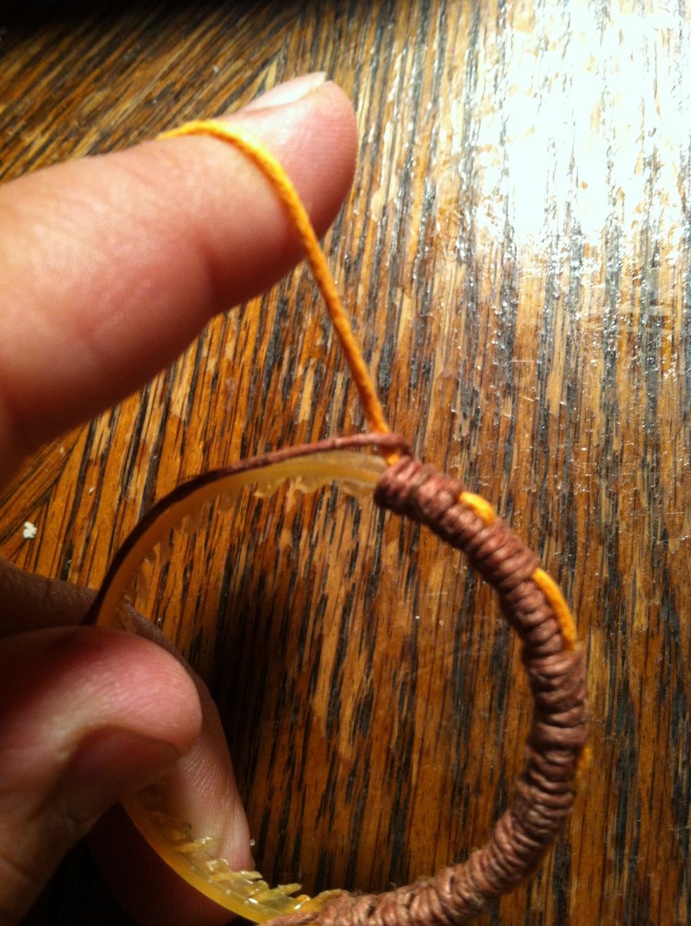 I wanted to wrap with my secondary string for a bit so I did an extra wrap and pulled my first string around my second; Pulling it tight against it. Then lay the first string against the ring.
