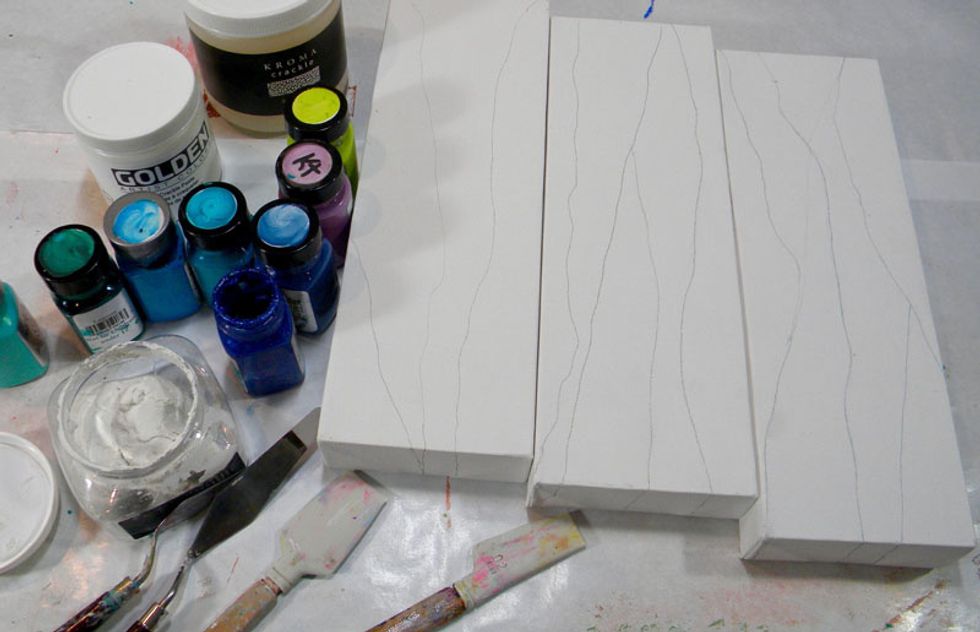I was inspired by canvases I'd seen on Pinterest with lots of texture, dimension and shimmer in flowing lines.  To start, draw lines on the canvases to show the patterns.