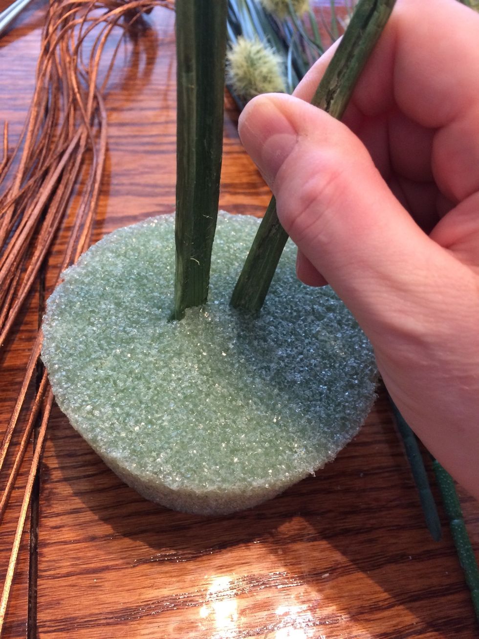 I wasn't sure of my plan so I started by adding the main, taller feature to the foam. Note the stems are fragile so I poked the foam first with scissors before poking in the stems.