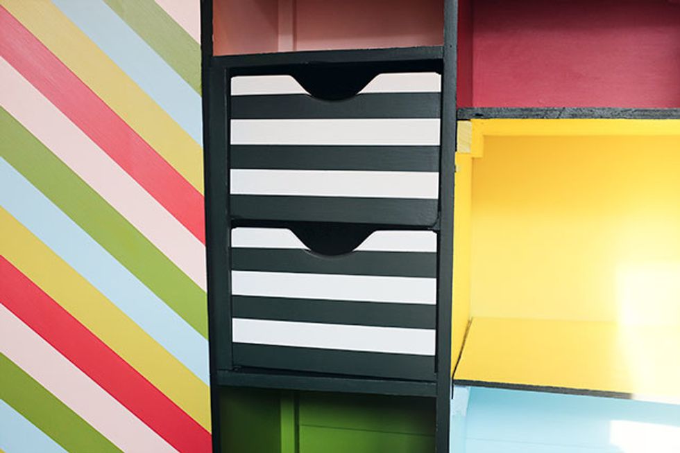 I went for a mix of horizontal and diagonal stripes, some colorful and some more restrained. I also painted each cubby a solid color, using the same mix of colors that were used for the stripes.