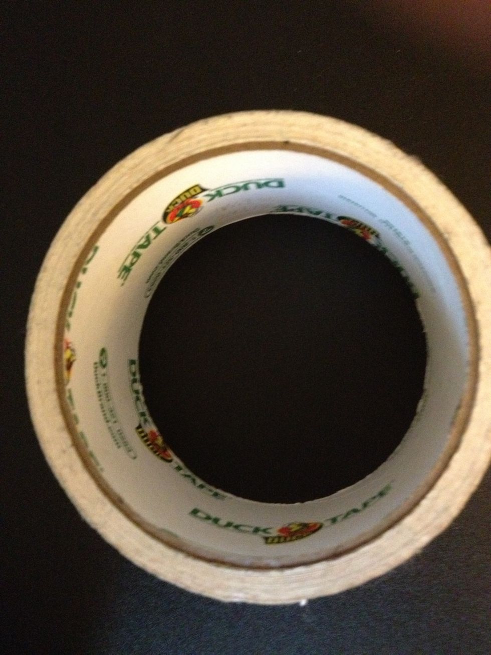 I will be using another roll of tape as my "cardboard" shape to show you how to tape the background on a shape other than a square or rectangle.