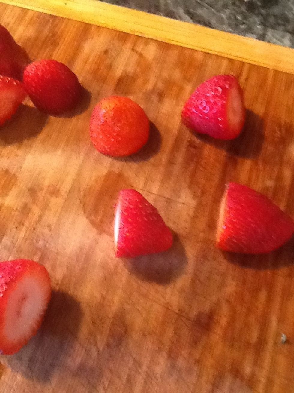 I will now make the strawberry topping. Clean the strawberries and remove the green tops. I had about 42 strawberries, I used about 20 of them for the top of the cheesecake