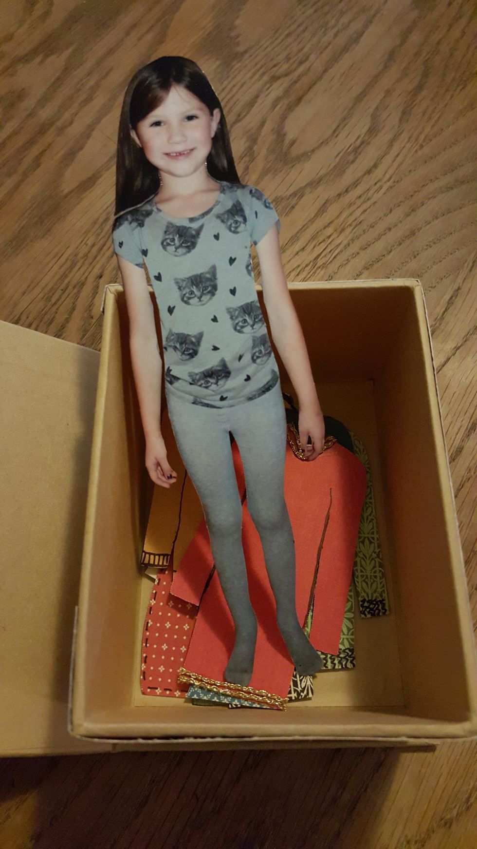 I will put all the clothes in the box. The doll will be packed together with a large, decorated tag in a cellophane envelope, and hung on the present.