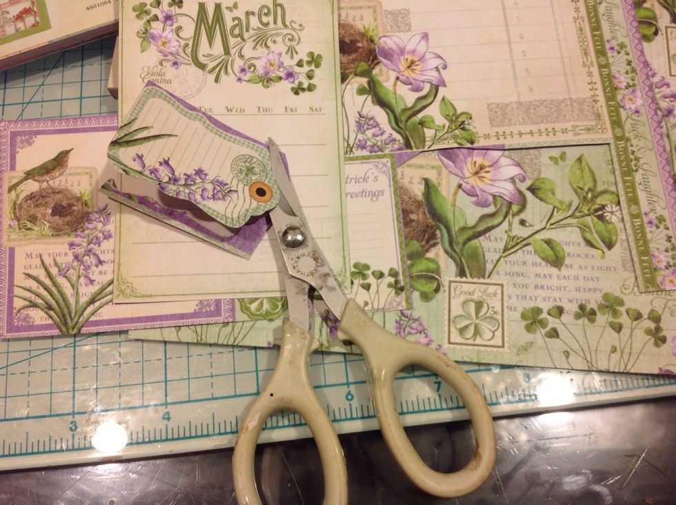 I will repeat same process for each month. Using both monthly sheets from 8x8 pad. Fussy cutting all the pieces from one, and covering front and back of tag with the other sheet.
