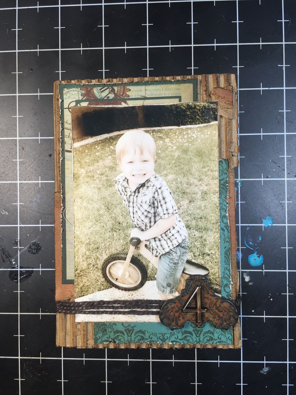 I wrapped the twine around the photo and matting, then added the metal embellishment and number.