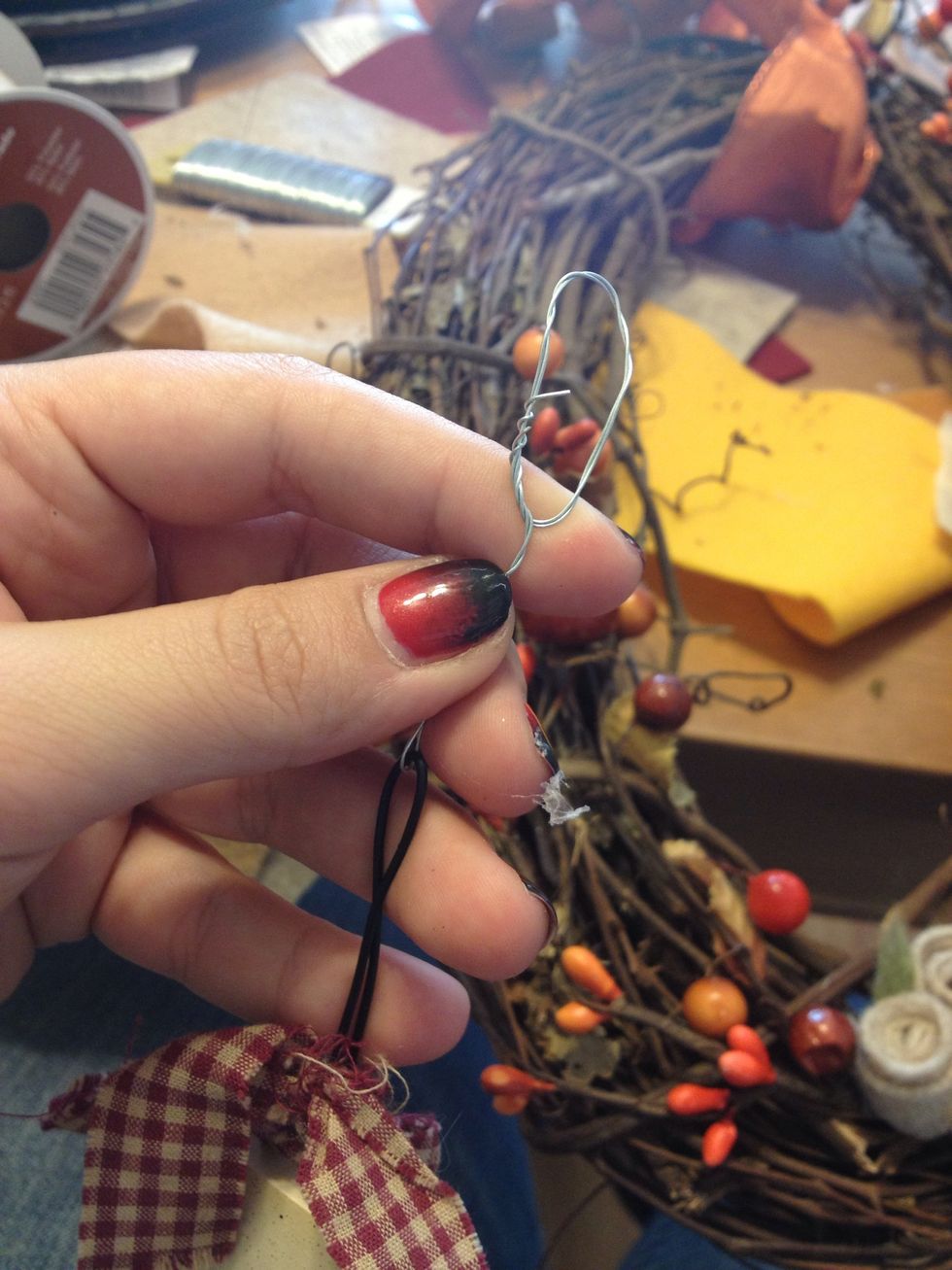 I wrapped the wire around the signs wire to give more length when it hangs.