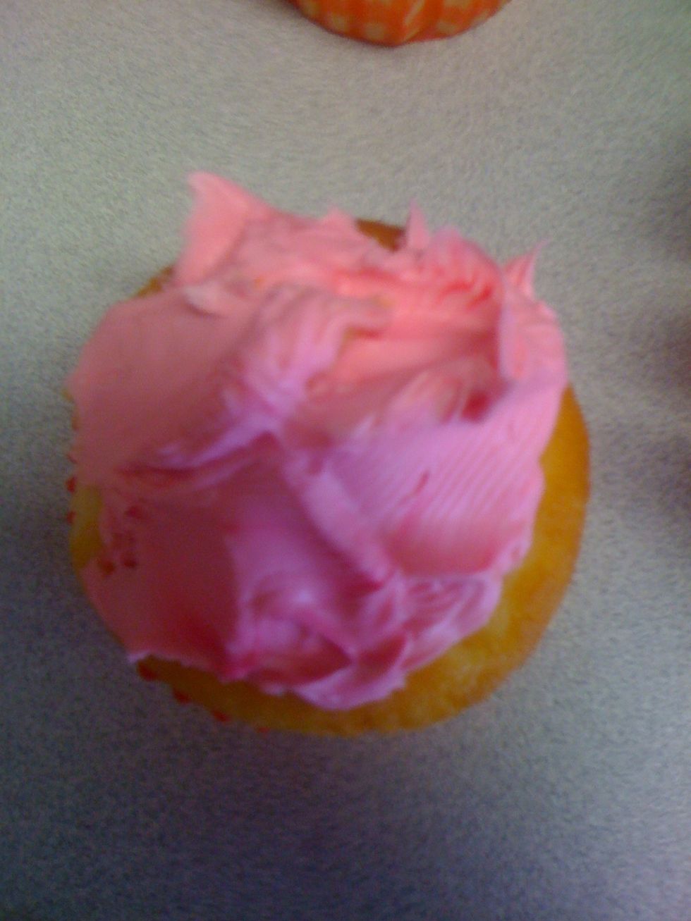 Ice cupcakes when cool, colour the icing depending on your petal colour