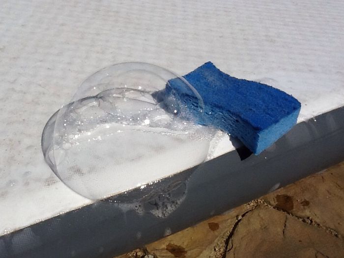 Identify the hole. One easy way is to pump the board slightly then use soap and a sponge to wipe the board. Where the bubble forms is your hole or slice.