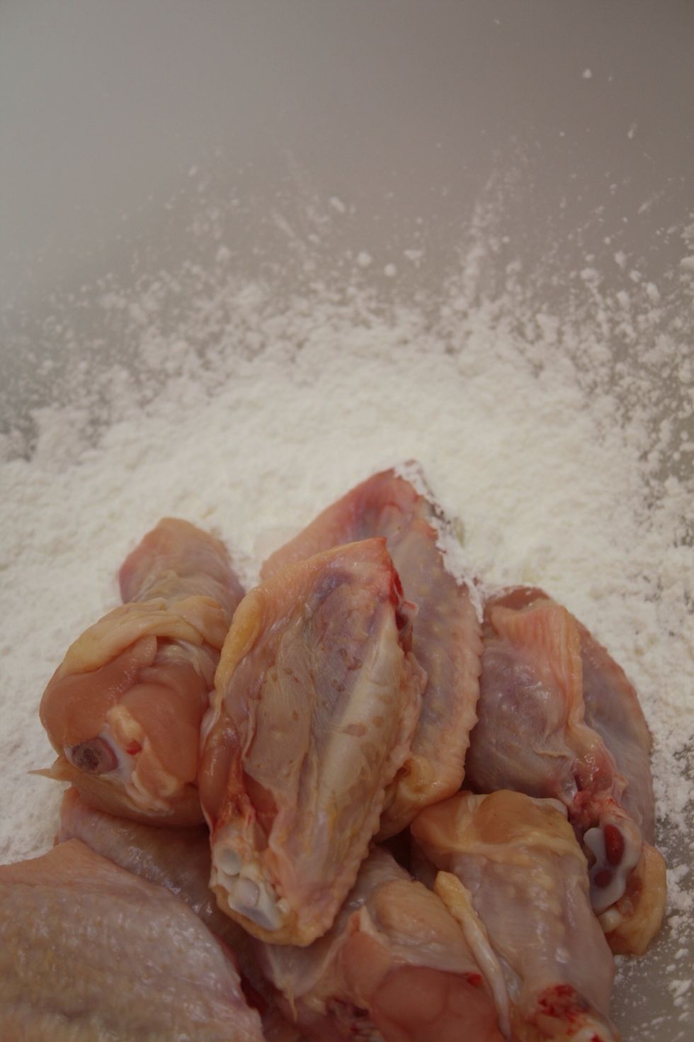 If I want my wings to have an extra crunch, I'll lightly dust them with cornstarch. Otherwise, I'll just fry them 'naked', no coating at all.