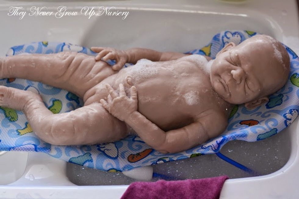 if it is a full body silicone then you will not need to rap the towel around the baby but if it is a half silicone then you will need to cover all non-plastic areas on the baby