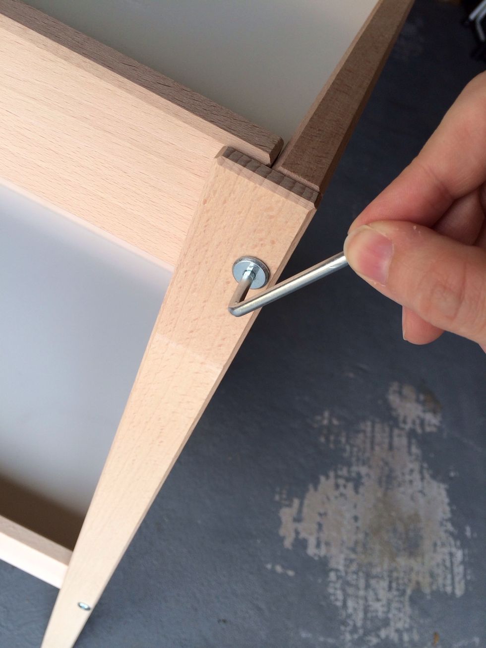 If it is already assembled as a diaper changing station, remove the legs using the Allen wrench included from IKEA. Taping this to the bottom of the changing table helps keep it from getting lost.