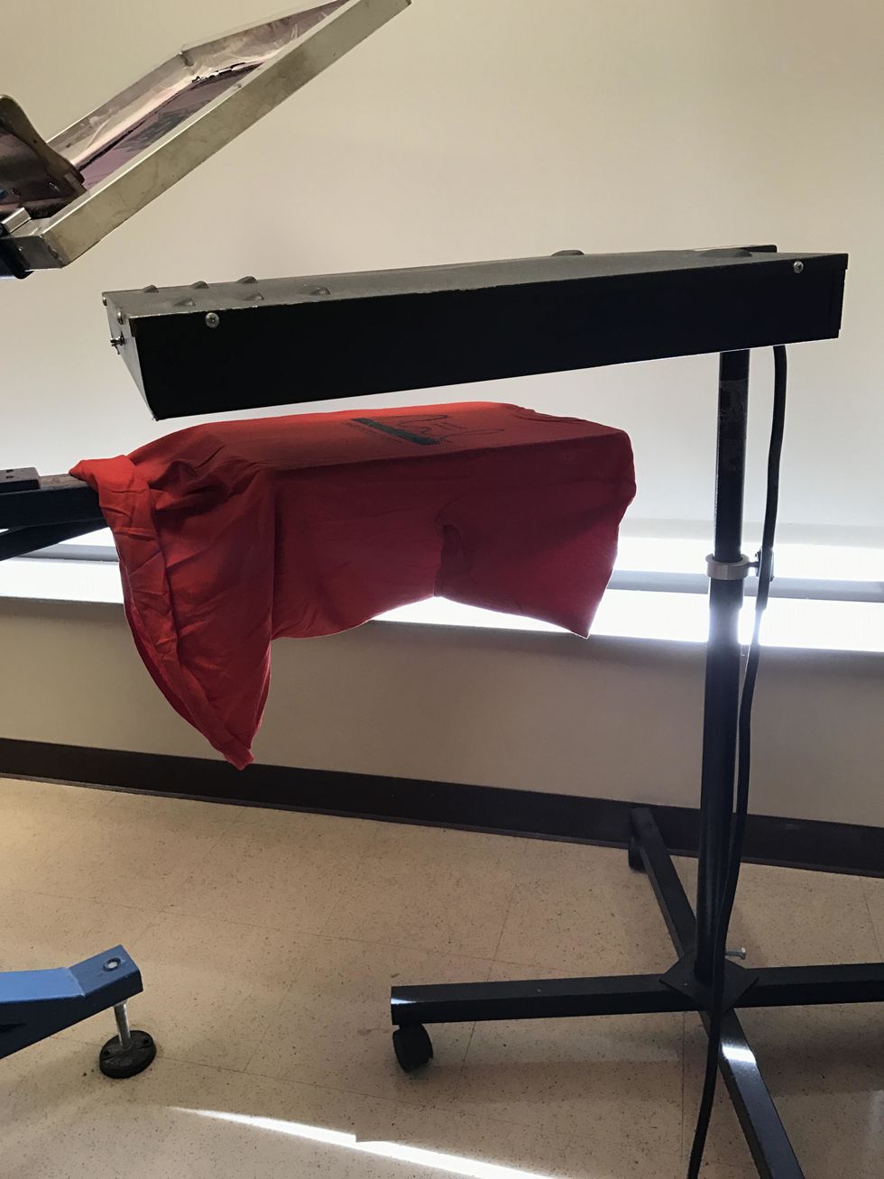 if it is two color process, you would put it under the heat lamp until the ink is dry. Touch the ink with your finger to check if it's dry, and if it is, then continue to squeegee the second layer.