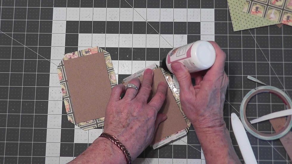 If necessary, add a bit of glue to the corners before attaching the sides down.