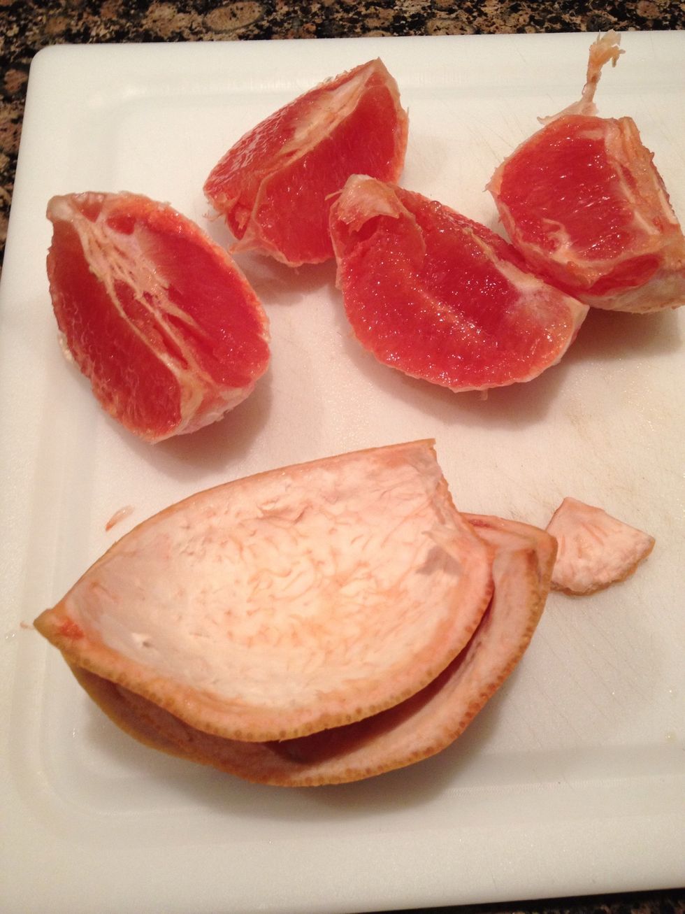 If necessary run your thumb around the outer edge of each quarter to perforate the pith before beginning to peel.  The peel should come off in one piece and the fruit should not be bruised.