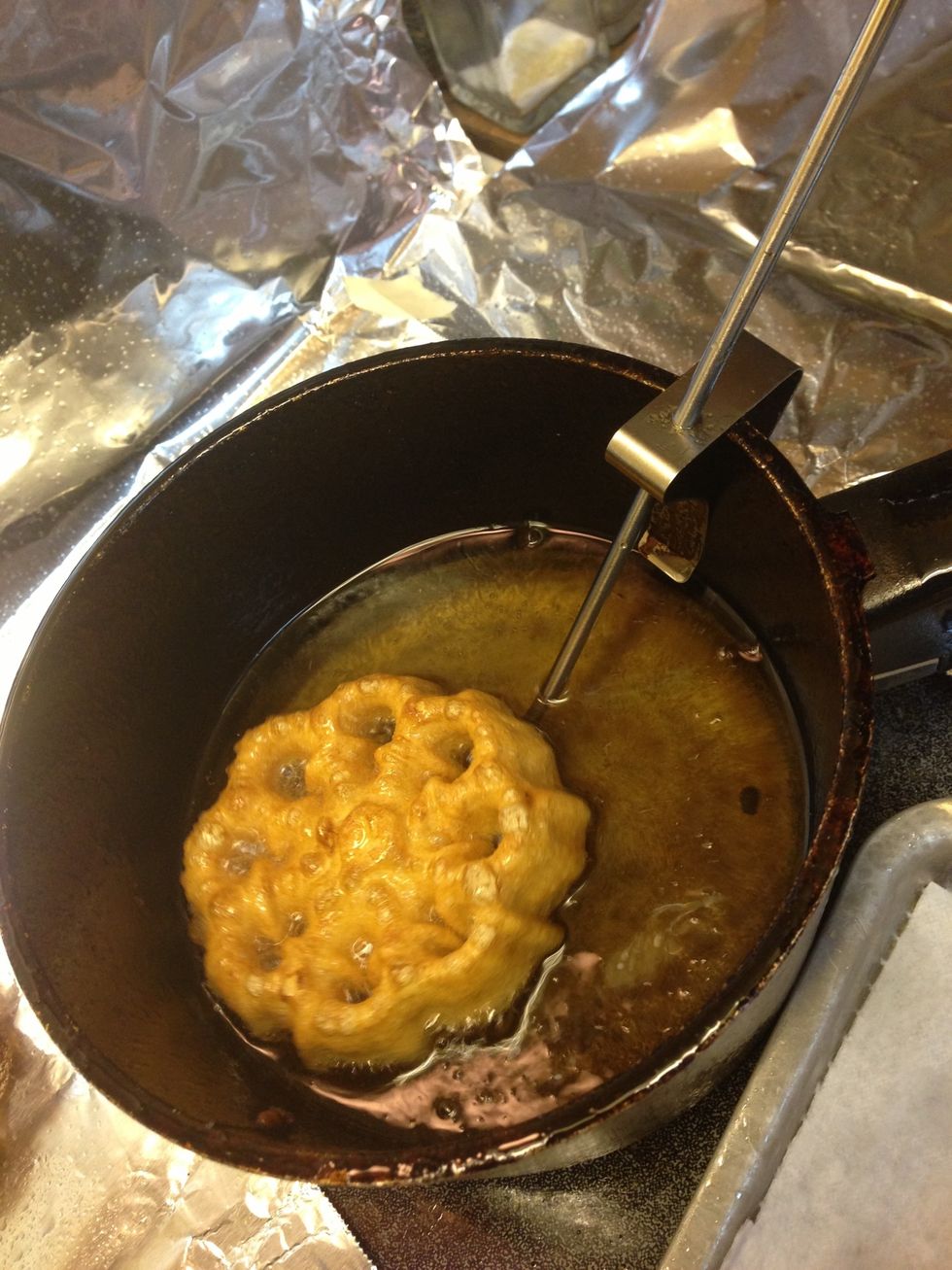 If rosette sticks onto iron, let it fry, then it should come off easily with fork. Drain on paper towel. Mine usually drop off the iron. Be patient... The first couple usually aren't quite as pretty.