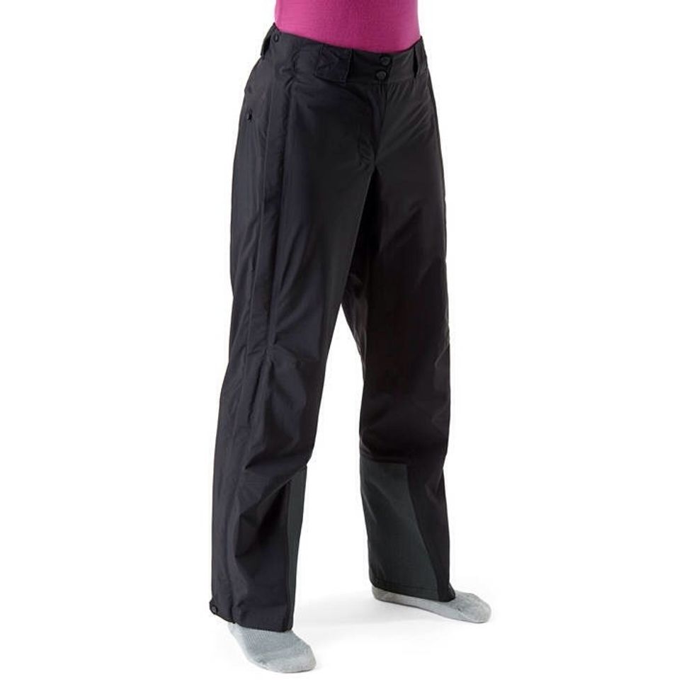 If ski pants are too expensive to buy, you can try find a water proof pants from outdoor store.  Men or women doesn't really matter. Just make sure it has a split bottom for your boots to be fit!