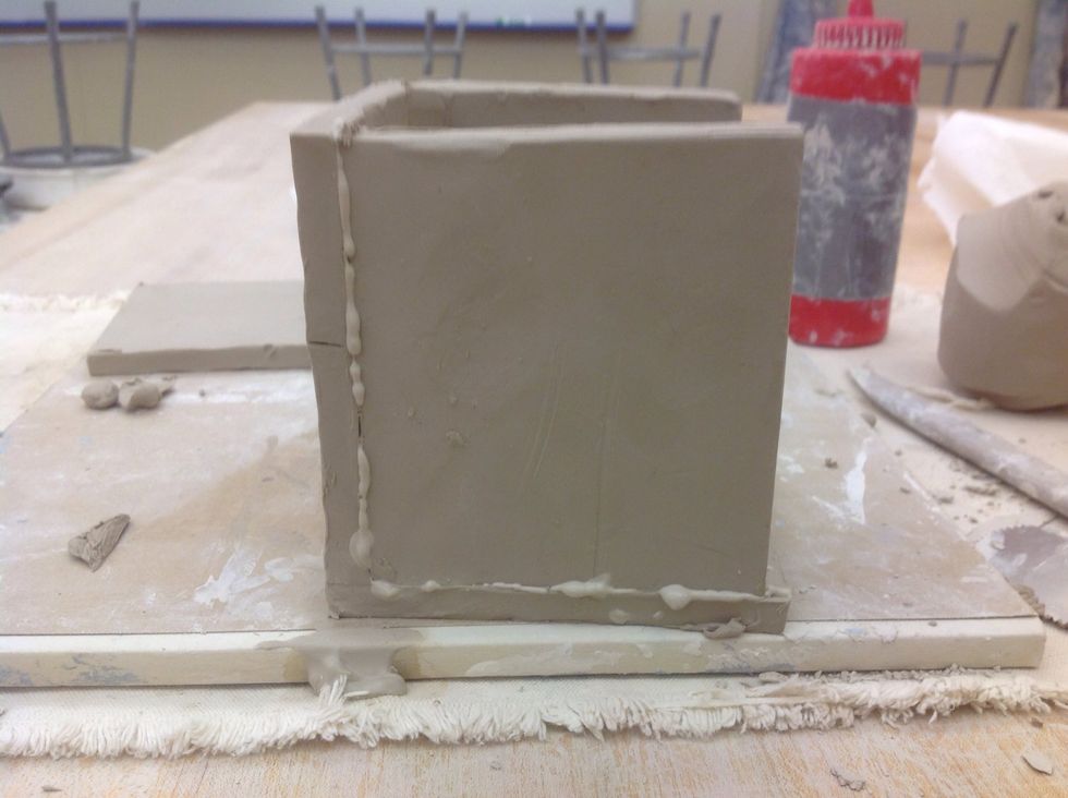 If slip oozes out, scrape with a metal rib.