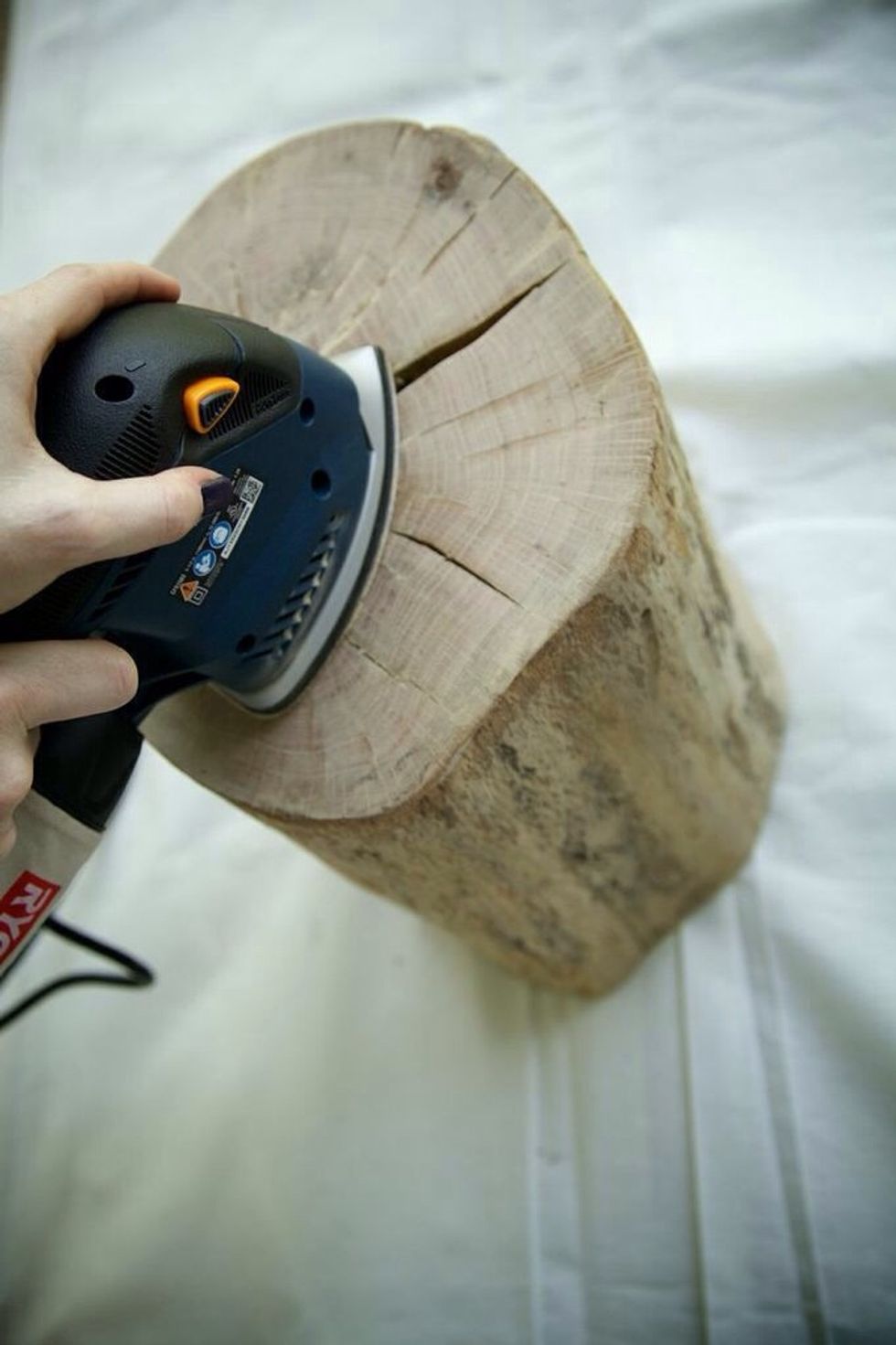 If the bark is already off the trunk, sand down the top and sides of the trunk until smooth and the top is level. I used a 220 grit sandpaper. Your stain should have a recommended grit to use.