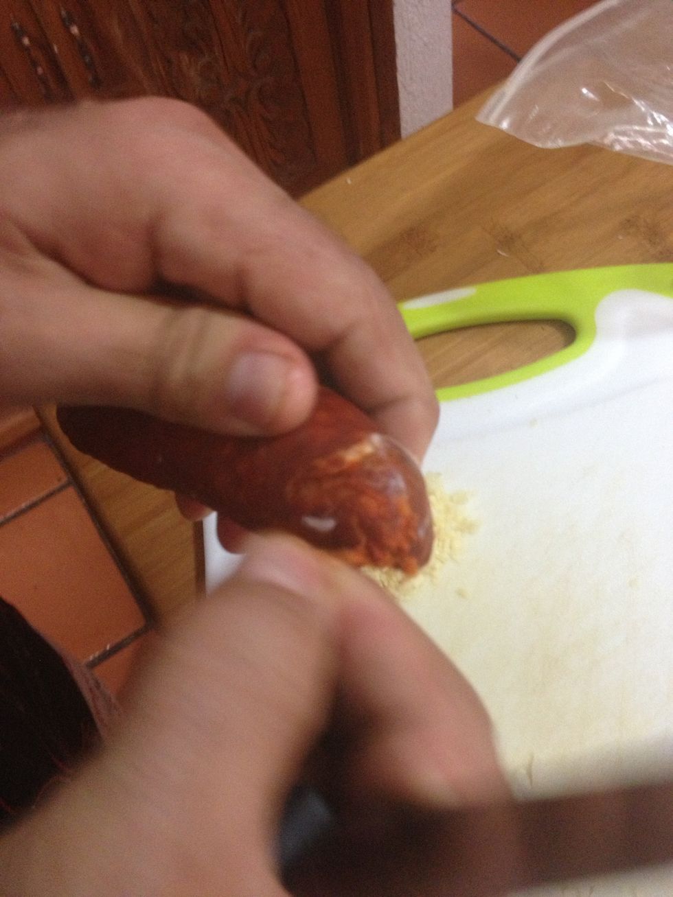 If the chorizo is hard enough to slice without the skin, you can remove it. If not, leave it on!