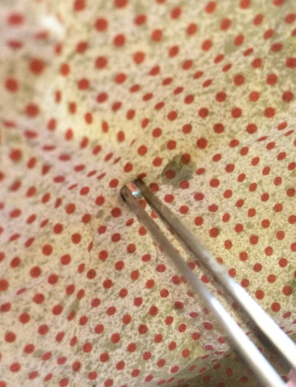 If the hole isn't big enough, insert your tweezers and gently widen the opening. Test your rope again, making sure the hole isn't so big your knot slips through.