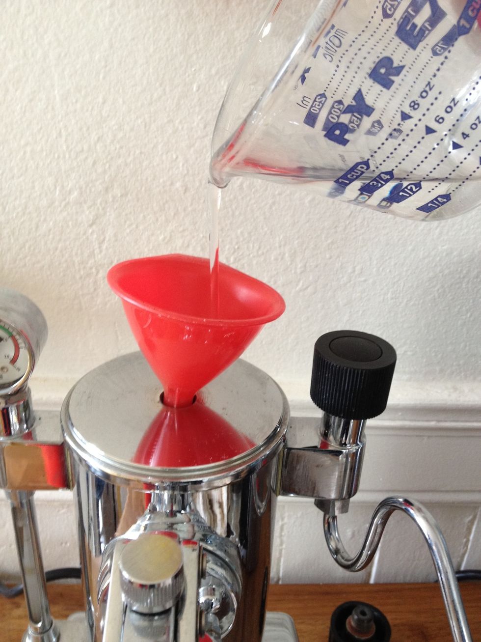 If the tank is low, unscrew the tank cap and fill it with water. A small funnel is handy here. Mind the water gauge so as not to overfill the tank. (It needs room to make steam!)