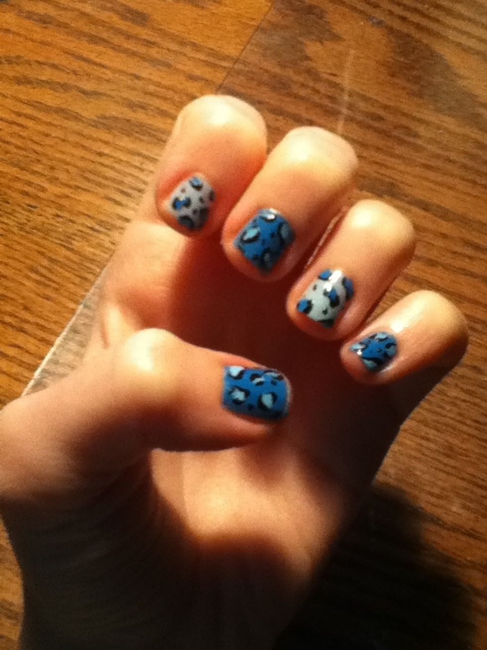 If there are some bare areas between the spots, make little dots with the black nail art polish to fill in the spaces.