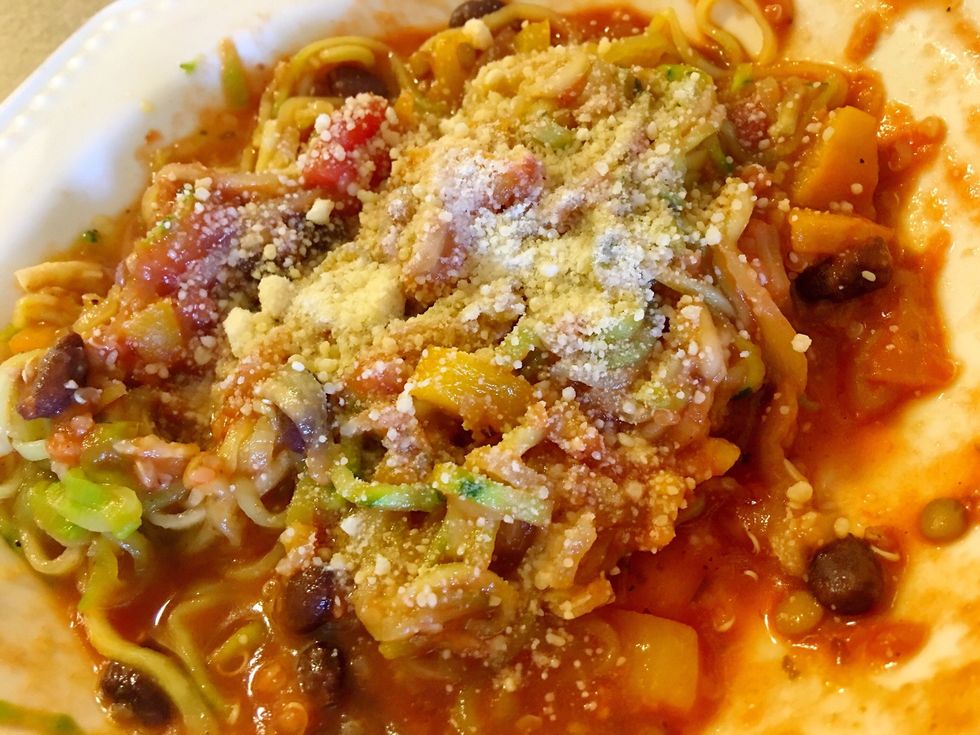 If you buy organic zucchini there's no need to peel. Wash it well and go. If you'd like to disguise the greenery, peel and it'll look close to pasta color after sauce is stirred in.