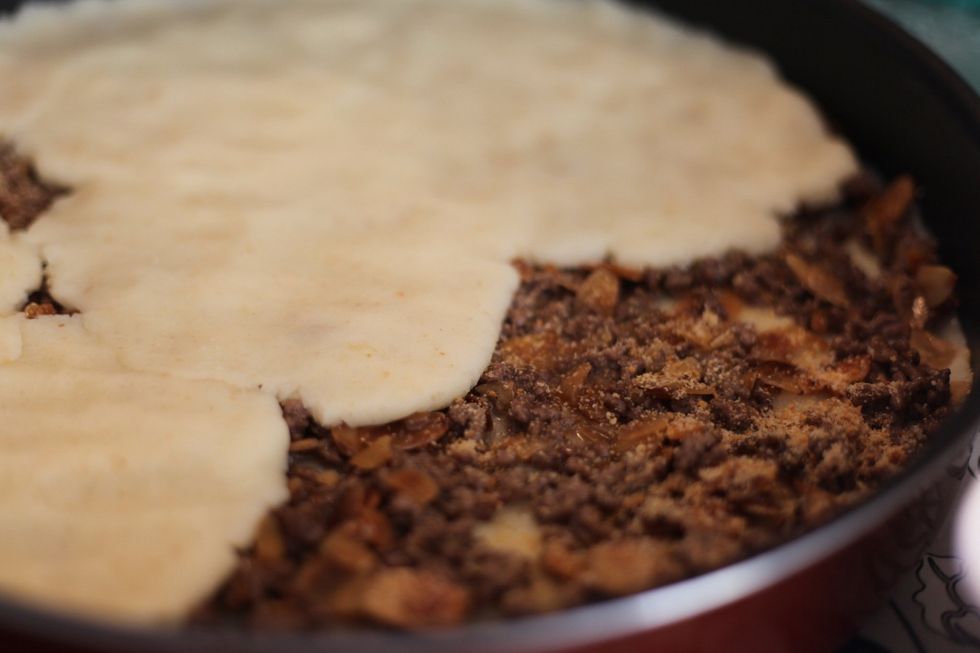 If you can see meat then you did something naughty Lol. But keep going. And cover it all. If you run out of potato, dip your hand in some water and redistribute the potato. It will work ;)