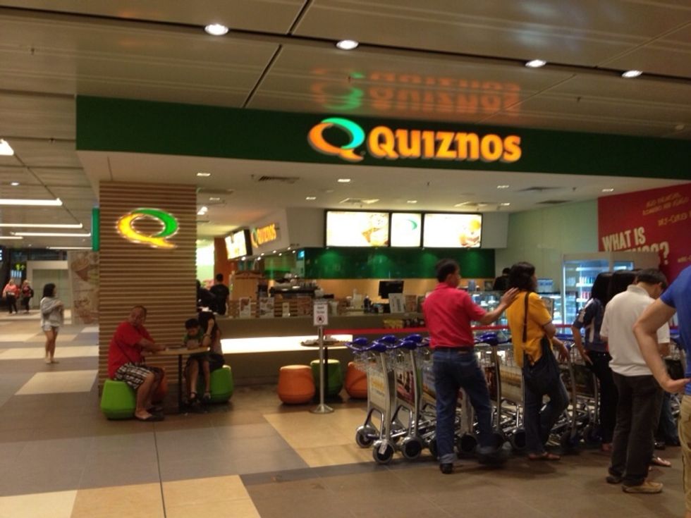 If you follow the signboard in the earlier step, you will pass by this fast food stall when you are on your way to take the escalator up to the first floor of the Arrival Hall