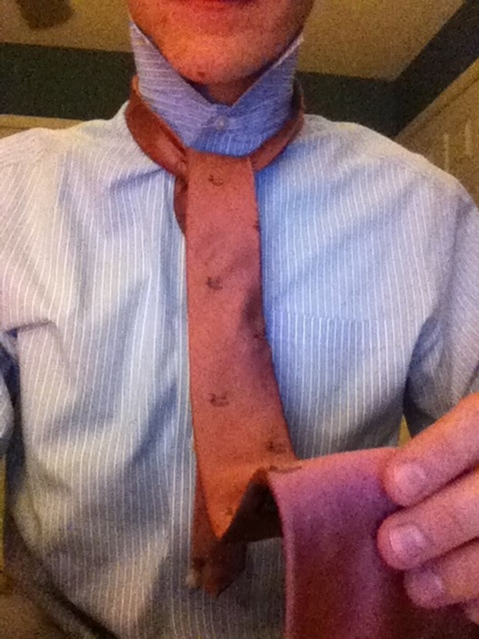 If you got through that, the worst is over. You should have the long, fat piece covering the knots you've made as well as the short, thin piece.